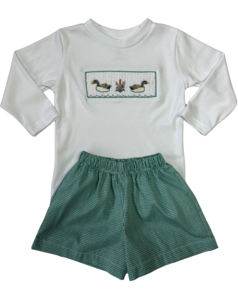 White long-sleeve shirt with duck smocked design and green checkered shorts on a white background