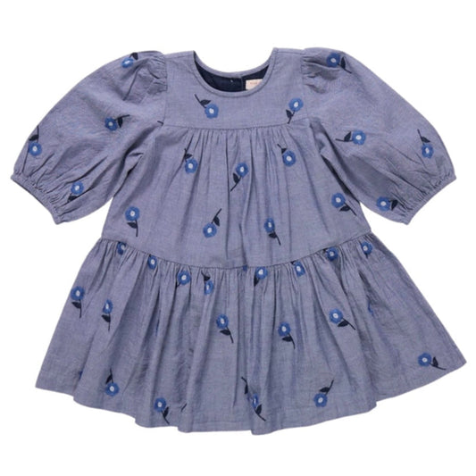 chambray blue dress with blue floral patterns embroidered on a blue background