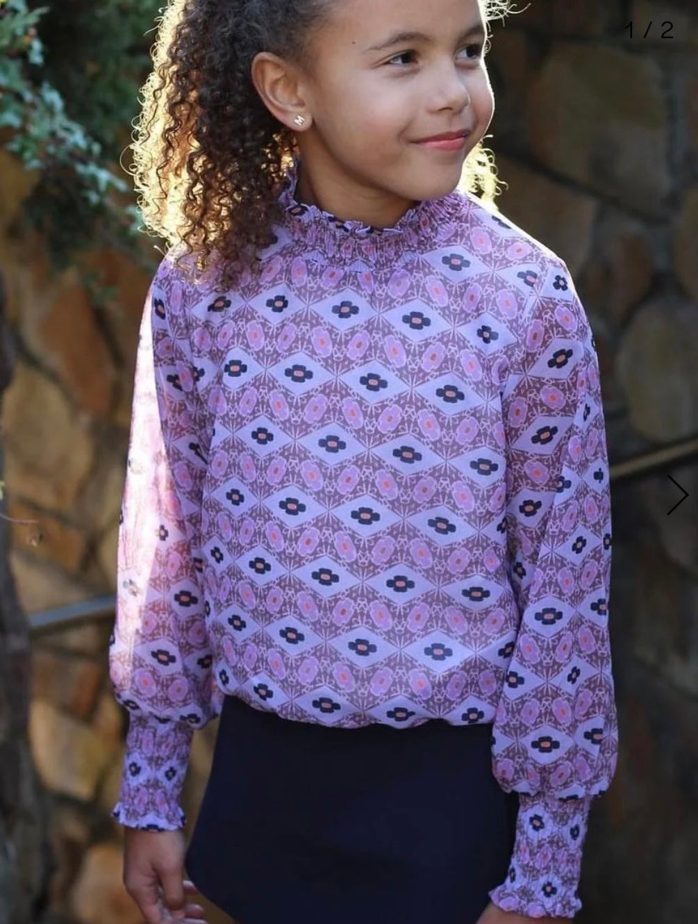 tween girls lavender and navy geometric print long sleeved top with ruffle neck and cuffs