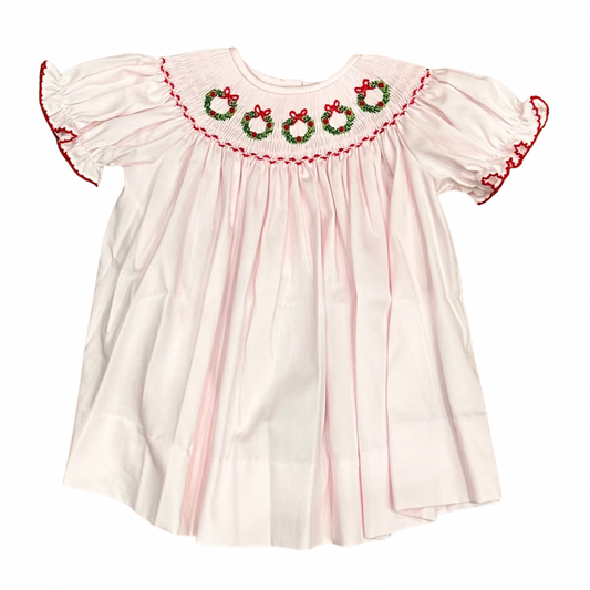 Pink bishop christmas dress with smocked neckline featuring green wreaths and red trim