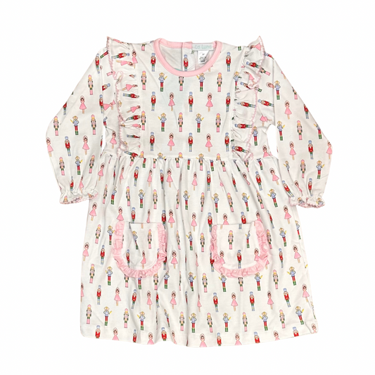 girls white knit dress with nutcracker pattern and ruffle and pockets