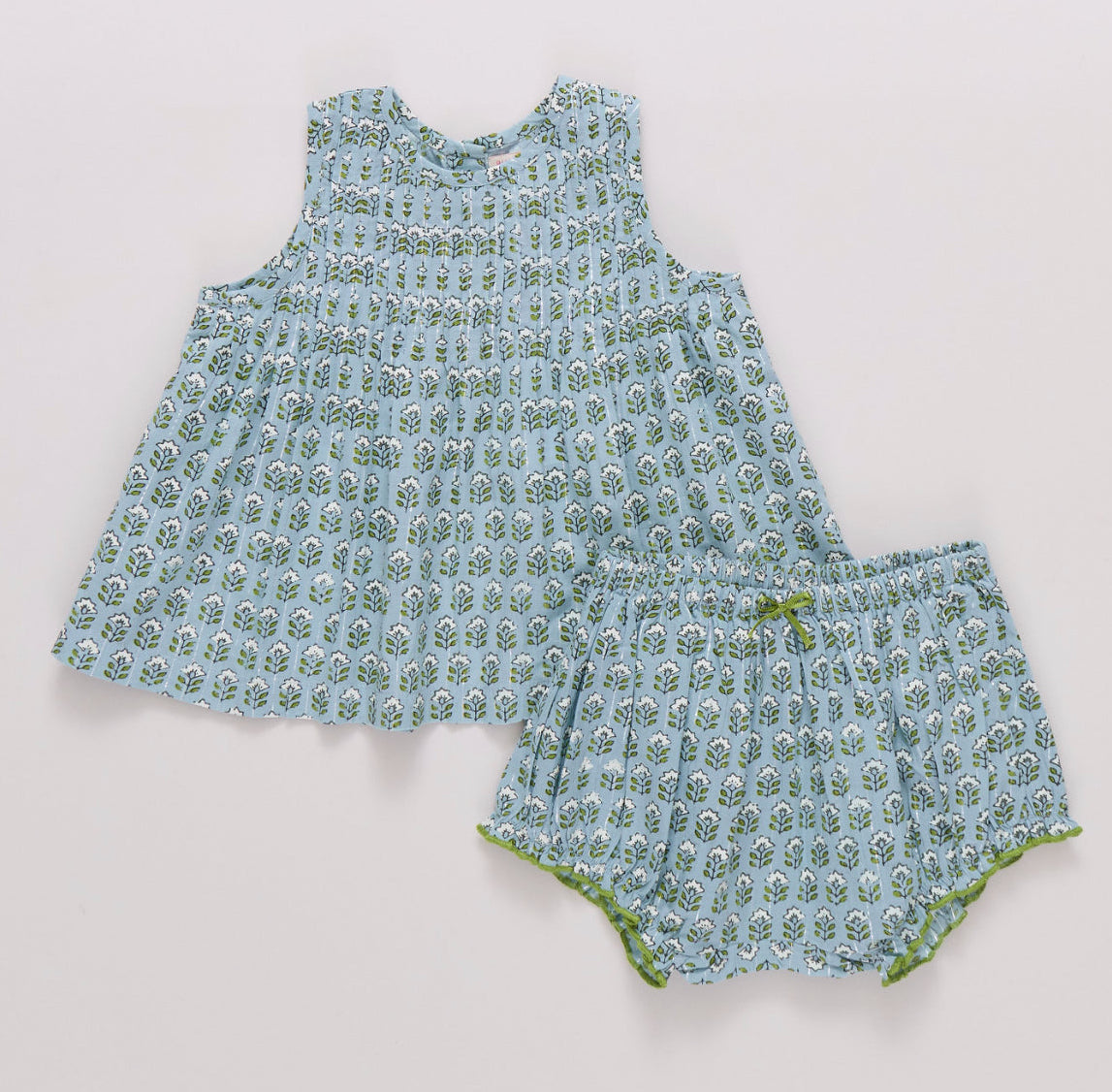 baby girls blue sleeveless dress and bloomer set with green and white flowers in a block print