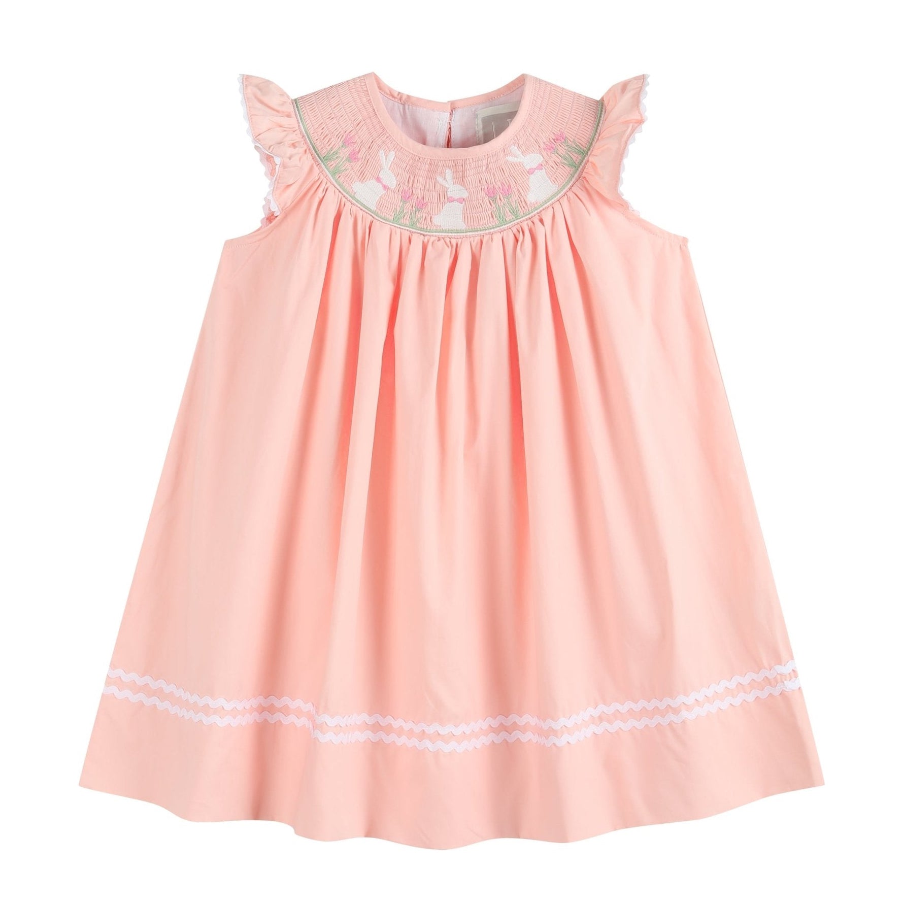 light pink flutter sleeve bishop dress with easter bunnies and flowers smocked at neckline and white ric rac at the bottom