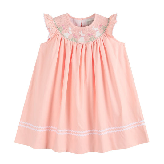 light pink flutter sleeve bishop dress with easter bunnies and flowers smocked at neckline and white ric rac at the bottom